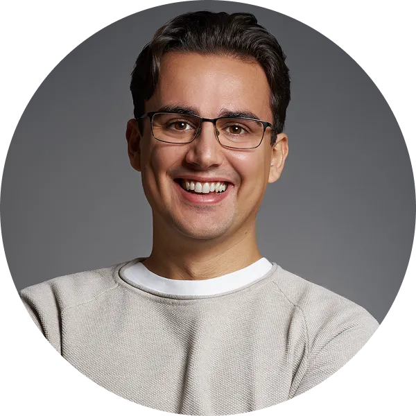 Linxact founder and CEO Daniel Lux smiling in front of a grey background