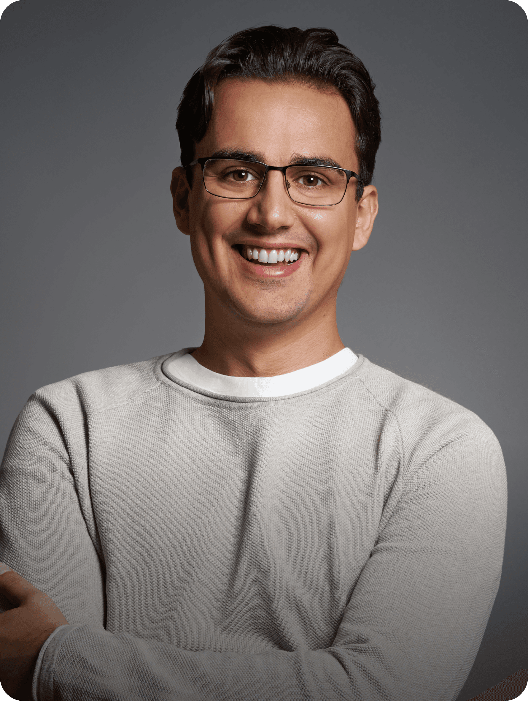 Linxact founder and CEO Daniel Lux smiling in front of a grey background