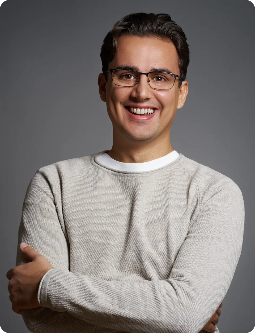 Linxact founder and CEO Daniel Lux smiling in front of a grey background